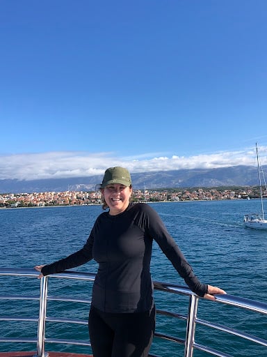 Jennie smiles from a boat heading out to sea